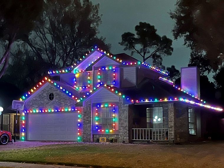 Home with multicolor roofline and window lights