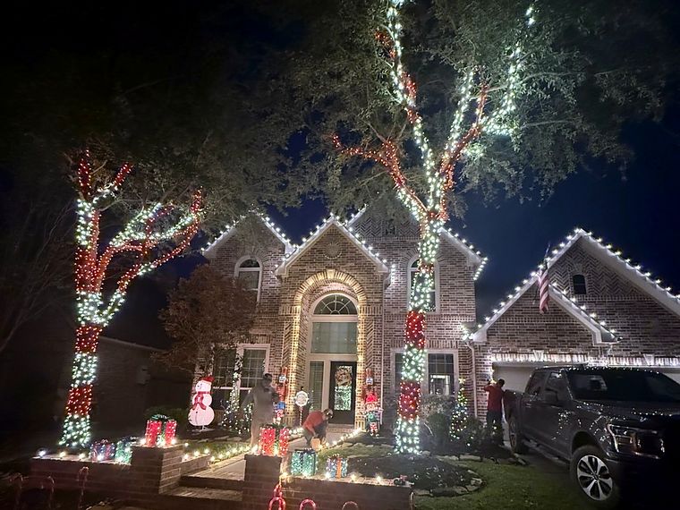 Home with lit trees, wreaths and holiday decorations